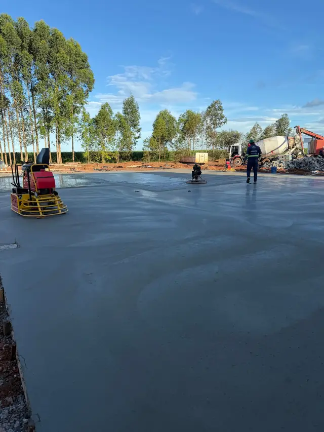 Pátio de manobra concretado e alisado em área rural.